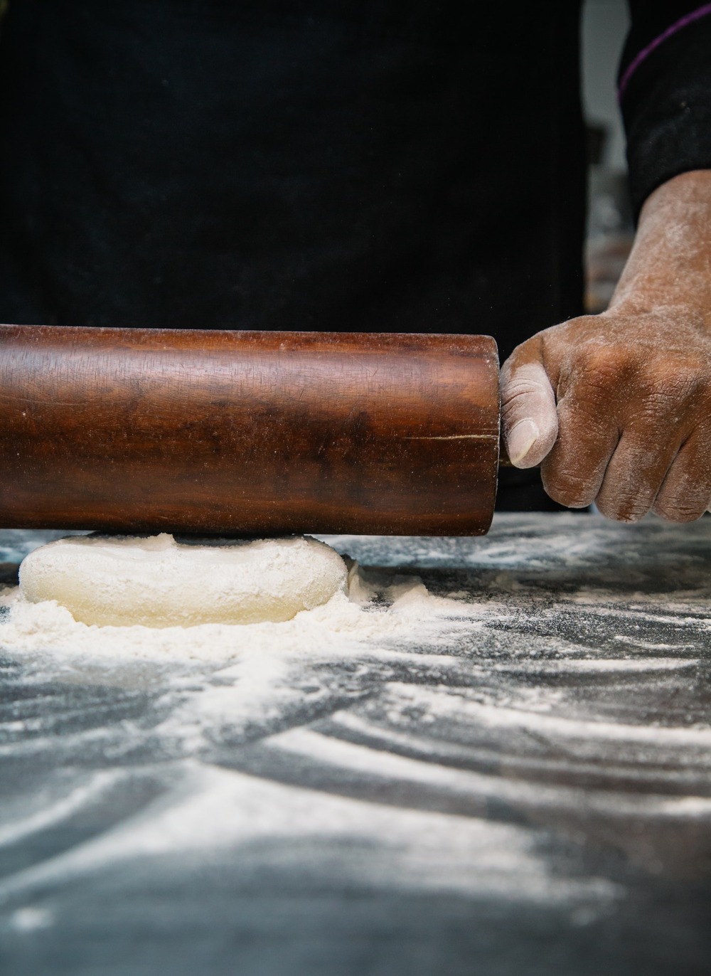 Rolling pin, dough, flour on a table